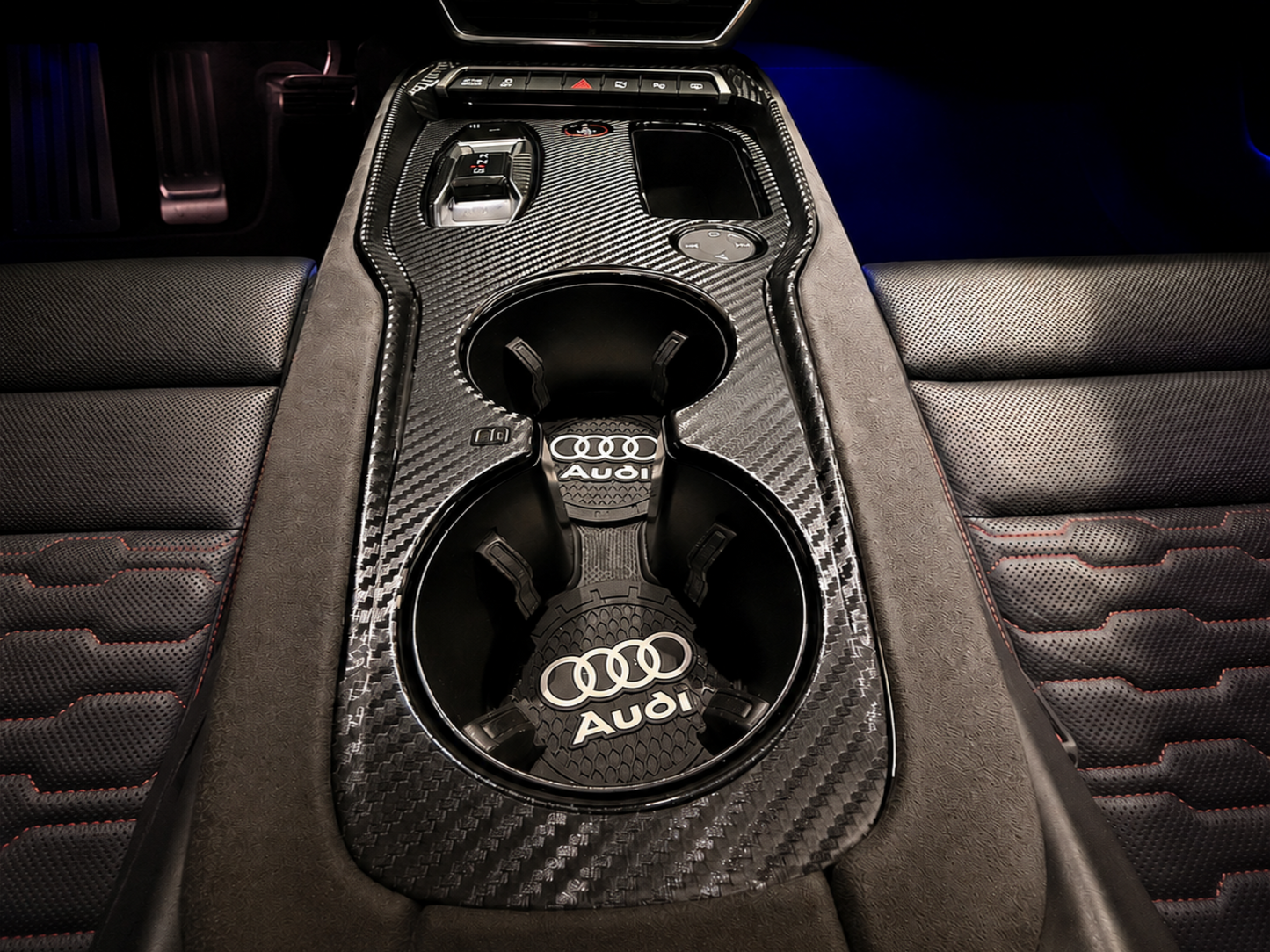 Audi E-Tron GT and Audi RS E-Tron interior carbon fibre PPF protection kit installed on the centre console hiding scratches and damage in the gloss black plastic trim.