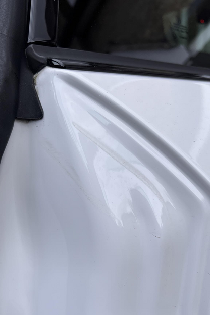 BMW 2 Series with damaged door shut. 