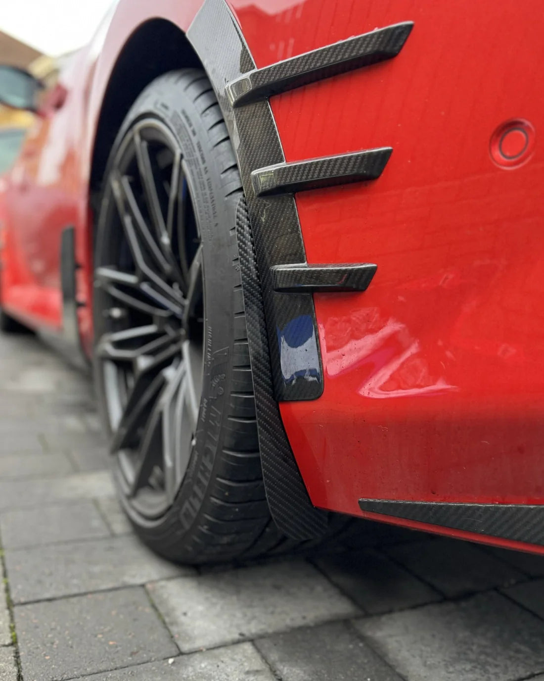 BMW M2 G87 rear arch guards mudflaps finished in carbon fiber.