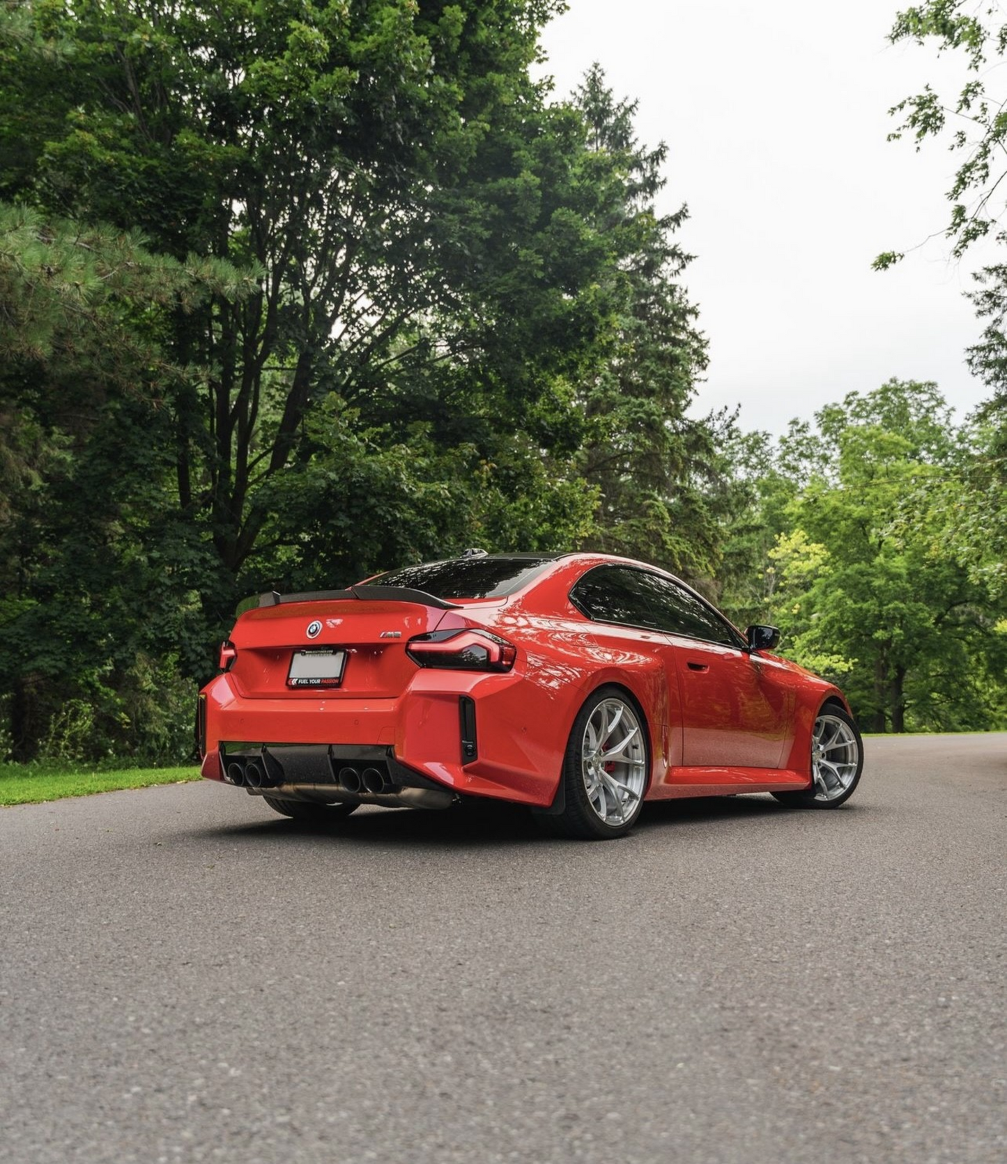 Red BMW M2 G87 showcasing with the Reverse Light and Reflector Tint in Dark. 
