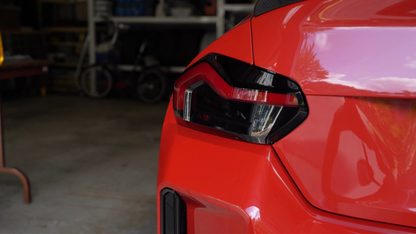 Red BMW M2 G87 model fitted with the Reverse Light Tint in Dark. 