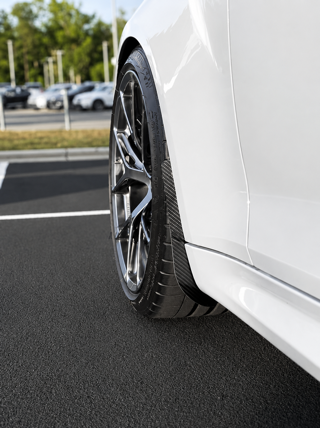 BMW M2 & M2 Competition F87 Carbon Fibre arch guards mudflaps installed on the front of the car.