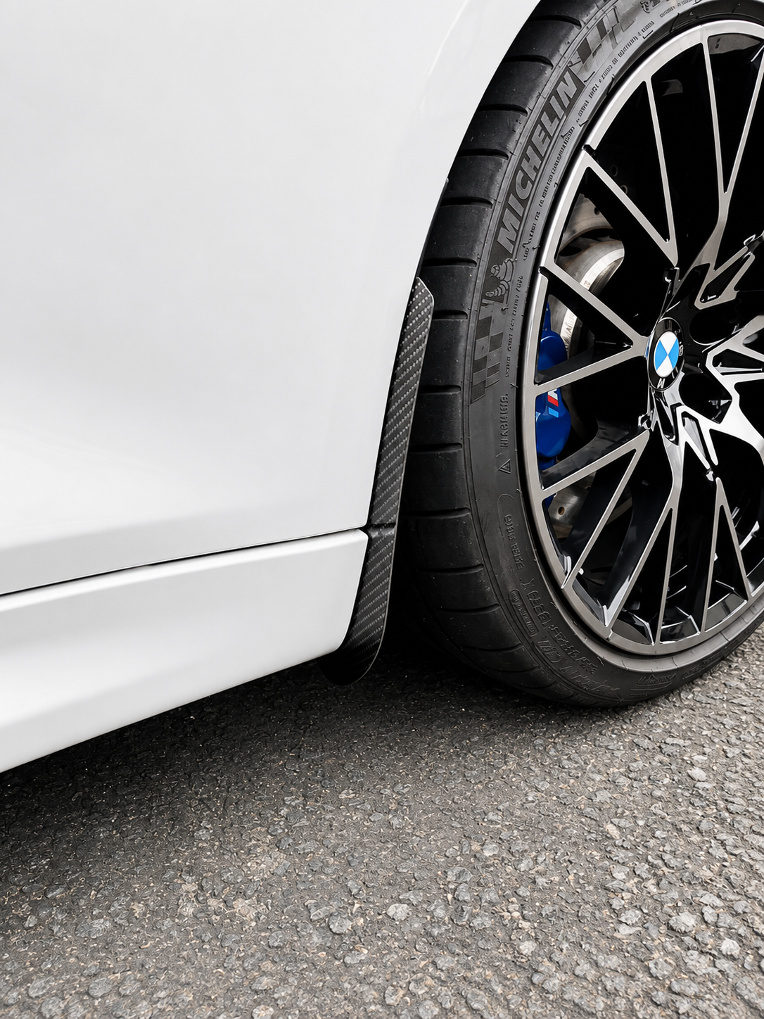 BMW M2 & M2 Competition F87 Carbon Fiber arch guards mudflaps installed on the front of the car.