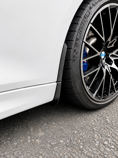 BMW M2 & M2 Competition F87 Carbon Fiber arch guards mudflaps installed on the front of the car.
