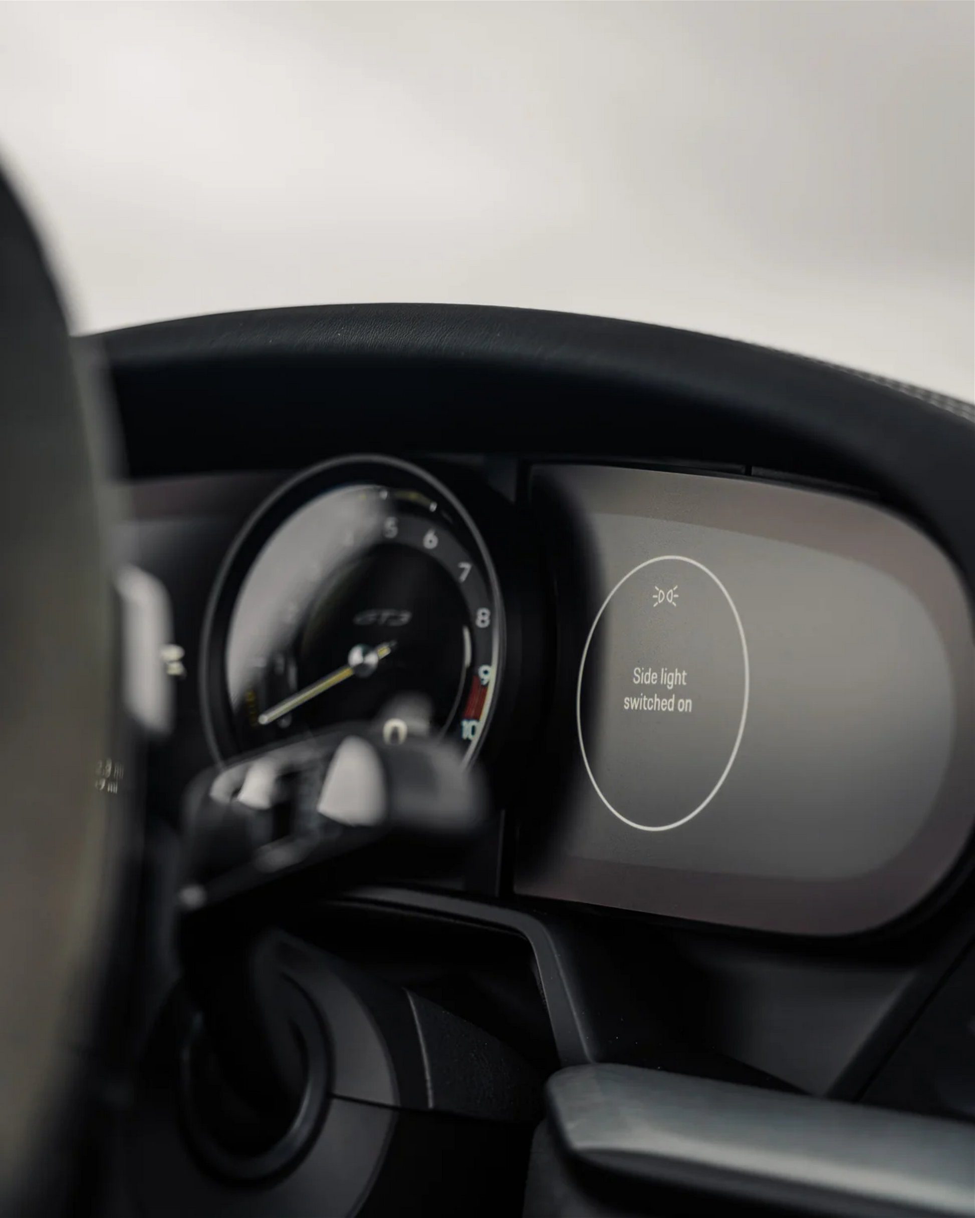 Close up of a Porsche 911 992 digital instrument cluster with an anti glare screen protector PPF.