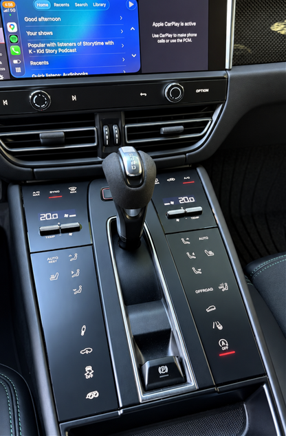 Close up of a Porsche Macan Gen 1 center console protected with matte satin PPF. The PPF protects the soft piano black interior trim from damage and fingerprints. It has the added benefit of being anti-glare which improves the driving experience.